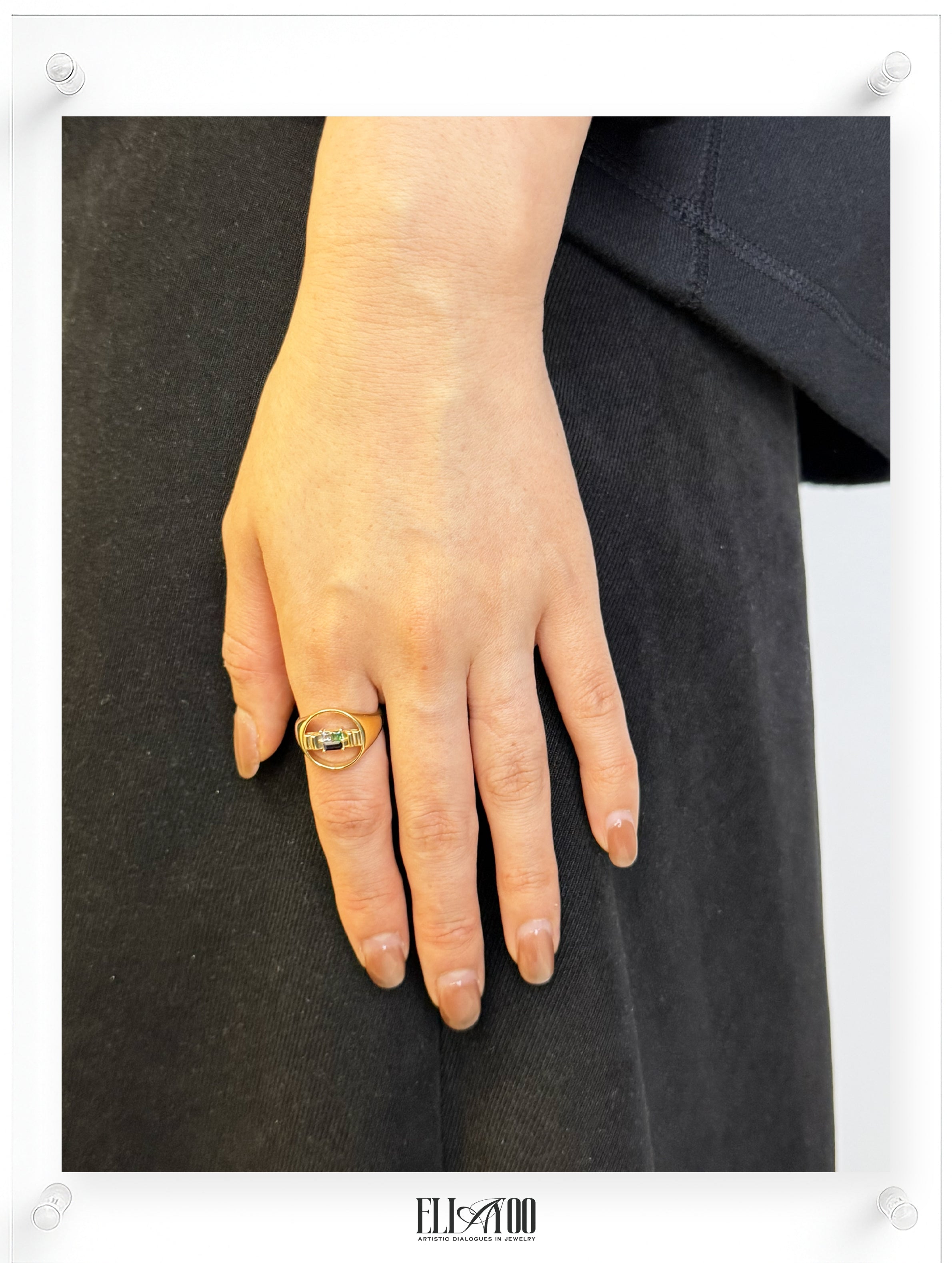 Model image of signet 10k gold ring featuring ribbon shape with Blue Spphire, Emerald, and Aquamarin