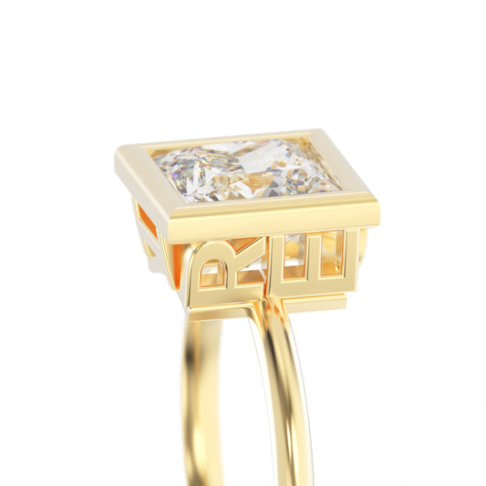 Gold ring with a square-cut diamond on a white background