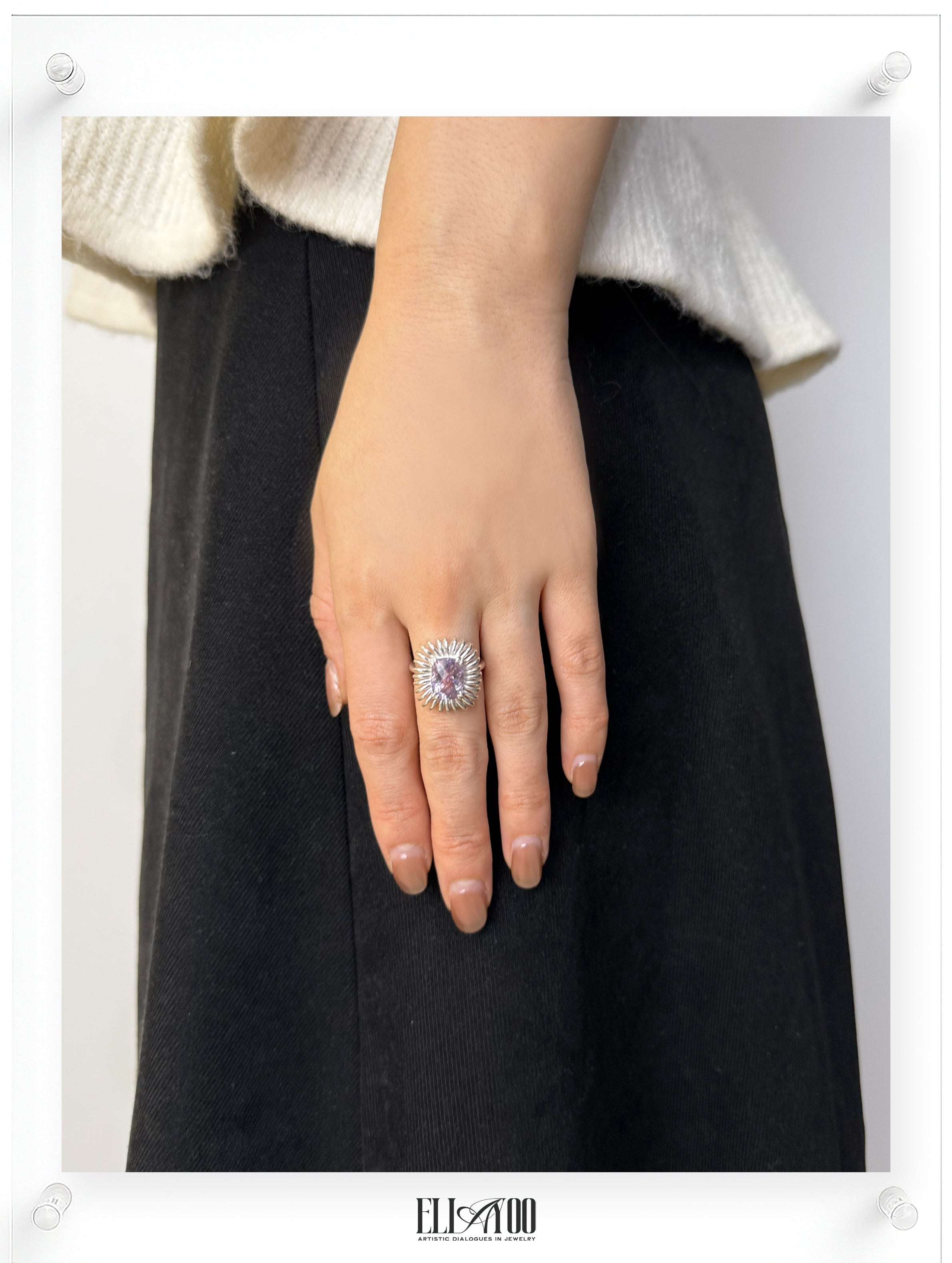 Model wearing Elongated Cushion cut Amethyst ring with sculptural silver petal setting, contemporary art-inspired design
