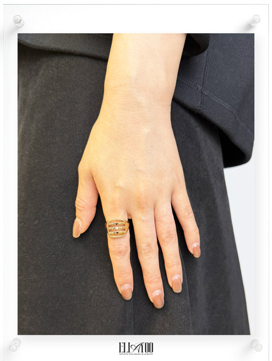 Model image of signet 10k gold ring featuring ribbon shape with black and white diamond