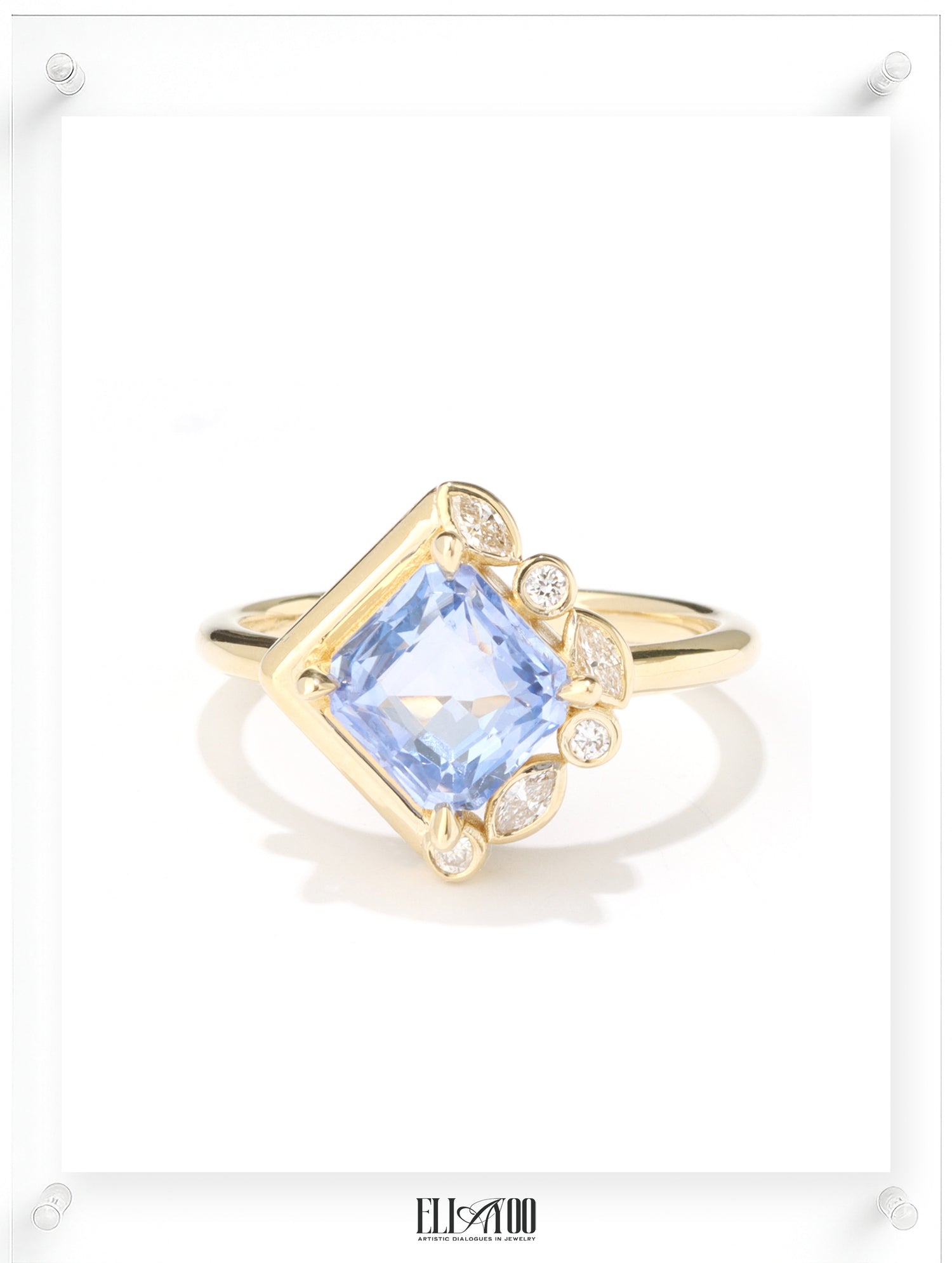 Gold ring with a blue gemstone on a white background