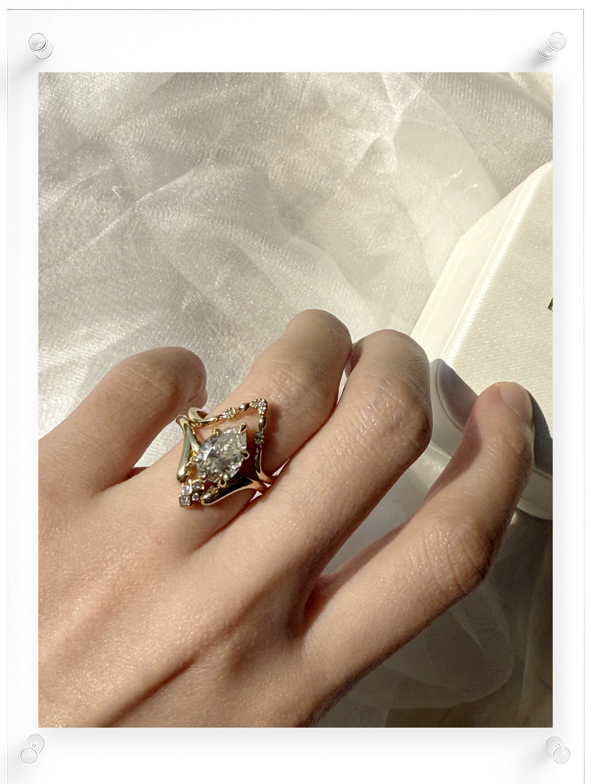 14K Yellow Gold Ring with Pear Shaped Diamond Center and Diamond Accent Stones Worn on Hand by Ella Yoo