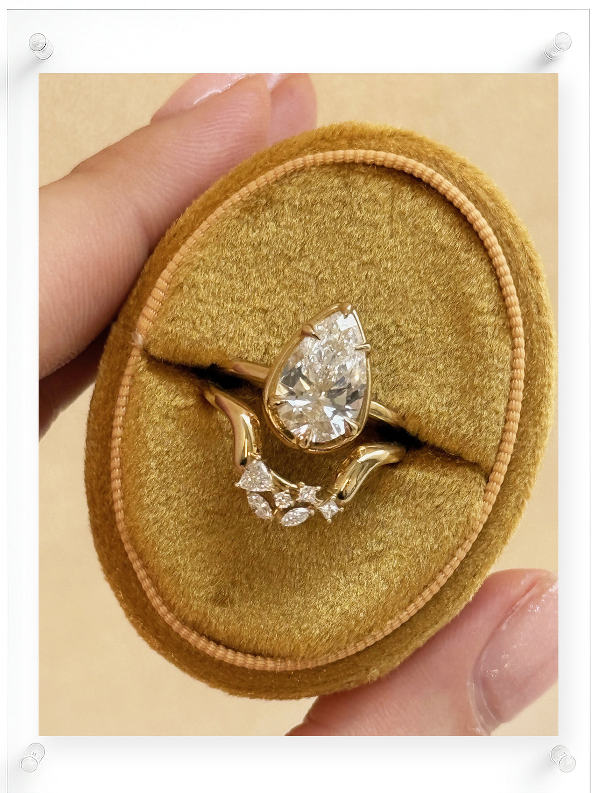 14K Yellow Gold Ring with Pear Shaped Diamond Center and Diamond Accent Stones on Velvet Display by Ella Yoo Jewelry