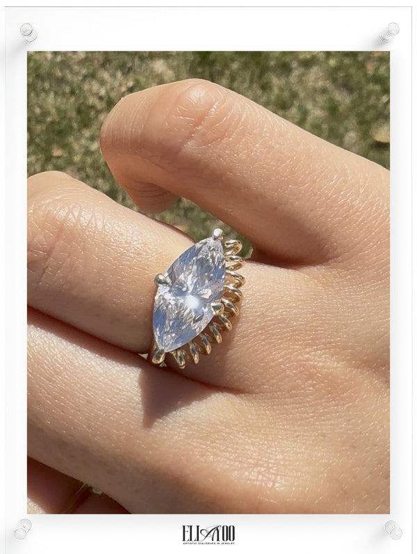 ella yoo artistic yellow gold marquise-cut diamond ring with a unique sculptural coiled wire setting, modern fine jewelry design on a model
