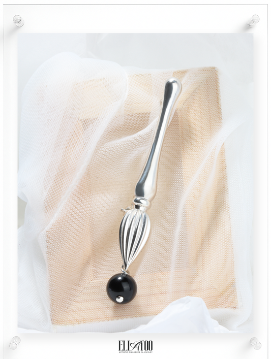 Front view of Silver brooch featuring a paint brush shape with a Onyx Sphere