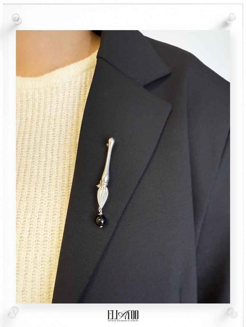 Model view of Silver brooch featuring a paint brush shape with a Onyx Sphere