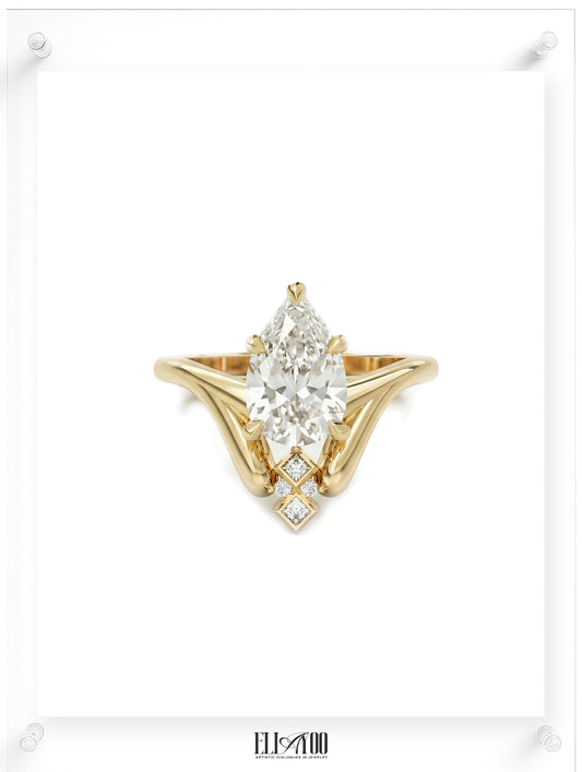 Front shot of 14k Yellow Gold Pear cut Diamond Ring with guard stone detail