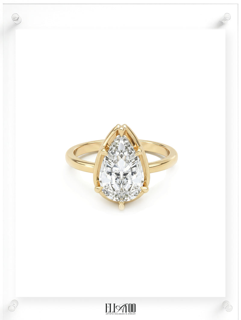 Front view of Pear cut diamond yellow gold ring