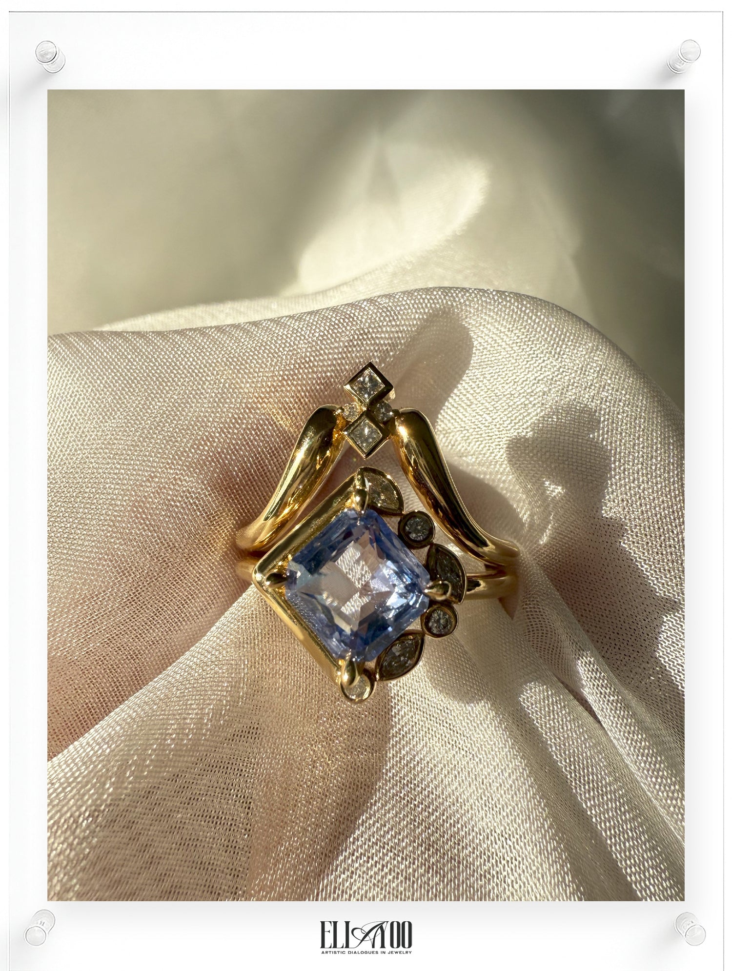 Gold ring with a blue gemstone on a beige fabric background