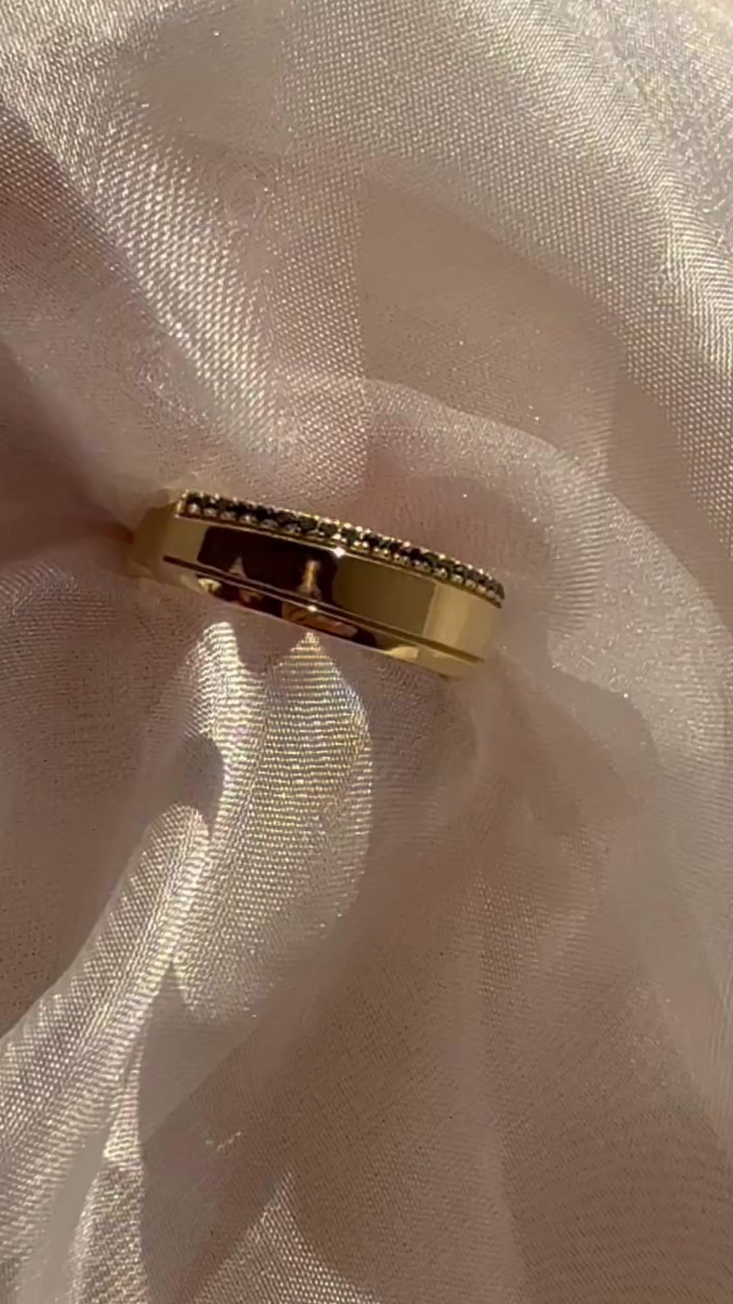 14K yellow gold band ring with black diamond pavé, close-up detail on sheer fabric, contemporary fine jewelry by Ella Yoo