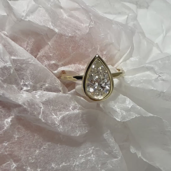 video of Pear Cut Diamond Ring with bezel setting featuring initials on the side